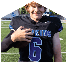 A young man wearing a white jersey with the number 10 on it. Description generated by AI