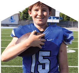 A young man wearing a white jersey with the number 10 on it. Description generated by AI