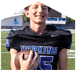 A young man wearing a white jersey with the number 10 on it. Description generated by AI