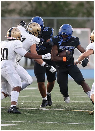 A football player wearing a blue jersey with the number 58 on it. Description generated by AI
