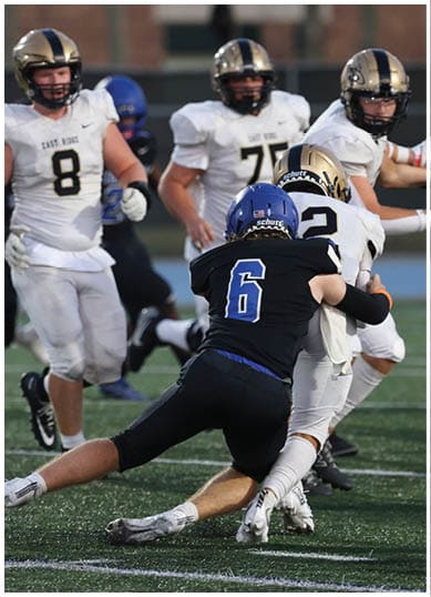 A football player wearing a blue jersey with the number 58 on it. Description generated by AI