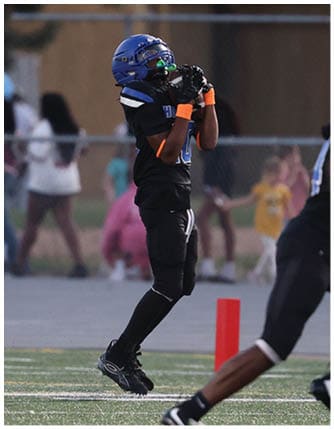 A football player running on the field. Description generated by AI