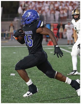 A football player running on the field. Description generated by AI