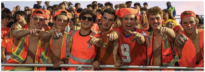 A group of football players on a field. Description generated by AI