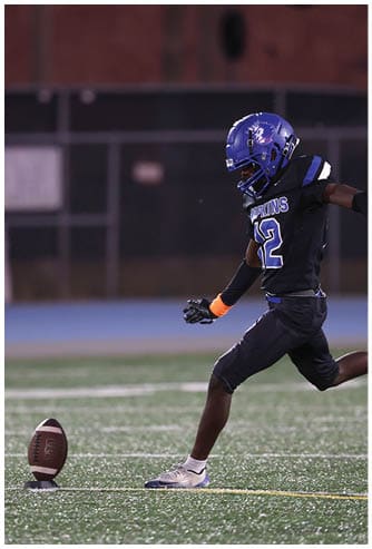 A football player running on the field. Description generated by AI