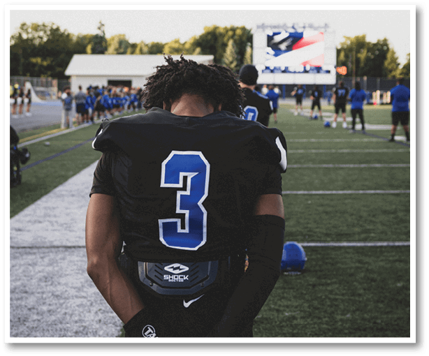 A group of football players wearing black jerseys with the number 3 on them. Description generated by AI