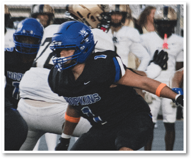 A group of football players wearing black jerseys with the number 3 on them. Description generated by AI