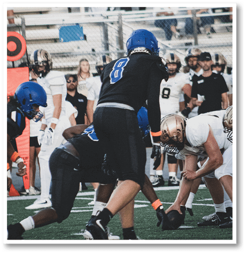 Two football players wearing black jerseys with the number 11 on them. Description generated by AI