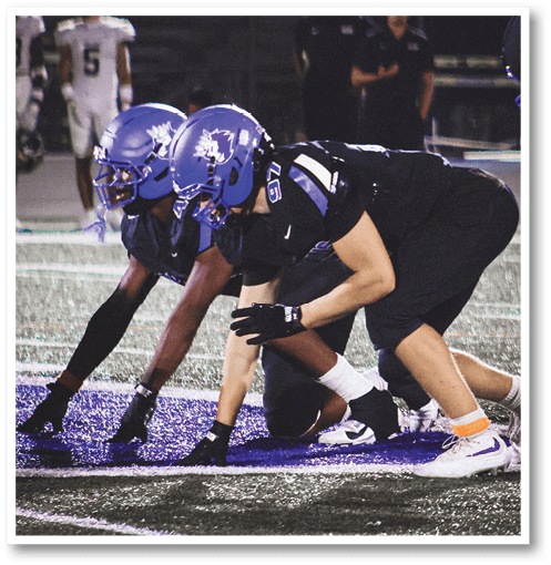 Two football players wearing black jerseys with the number 11 on them. Description generated by AI