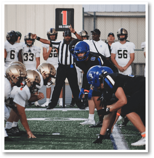 A football player wearing a black jersey with the number 6 on it. Description generated by AI