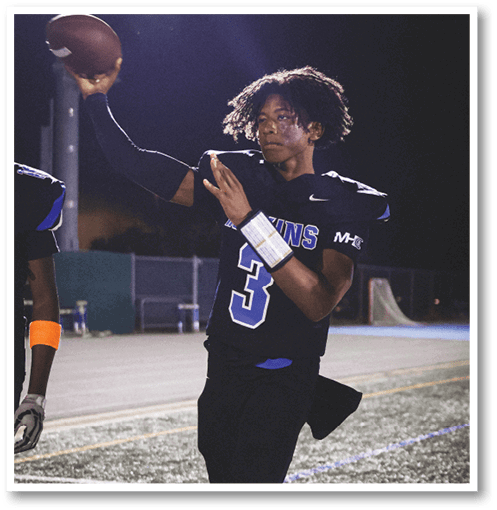 A football player wearing a black jersey with the number 6 on it. Description generated by AI