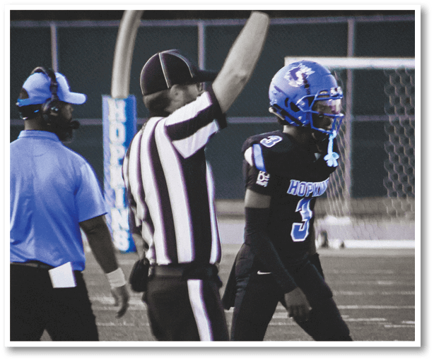 A football player is kicking a football on a field. Description generated by AI