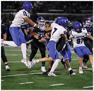 A football player running on the field. Description generated by AI