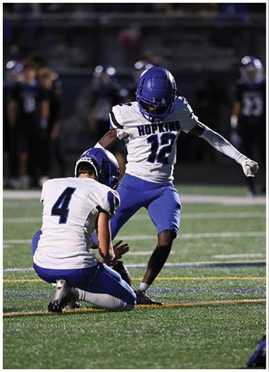 A football player wearing a blue jersey with the number 58 on it. Description generated by AI