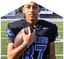 A young man wearing a white jersey with the number 10 on it. Description generated by AI