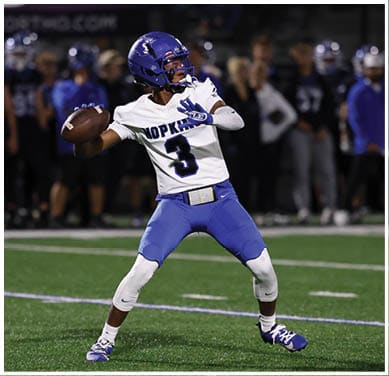 A football player running on the field. Description generated by AI