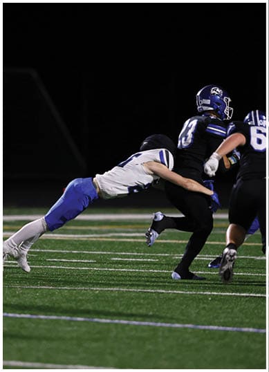 A football player wearing a blue jersey with the number 58 on it. Description generated by AI