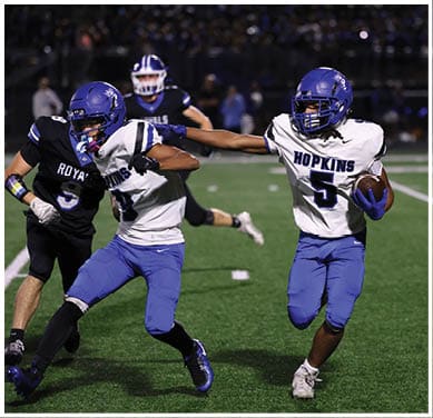 A football player running on the field. Description generated by AI
