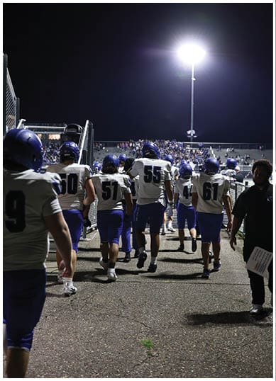A football player wearing a blue jersey with the number 58 on it. Description generated by AI