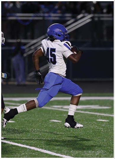 A football player wearing a blue jersey with the number 58 on it. Description generated by AI