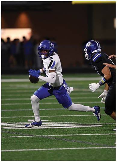 A football player wearing a blue jersey with the number 58 on it. Description generated by AI