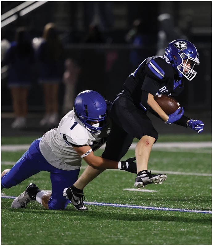 A group of football players wearing black and white uniforms. Description generated by AI