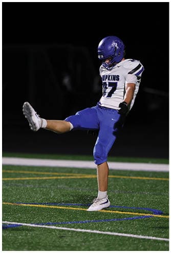 A football player running on the field. Description generated by AI