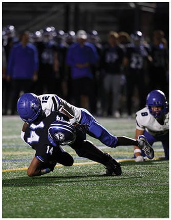 A football player running on the field. Description generated by AI