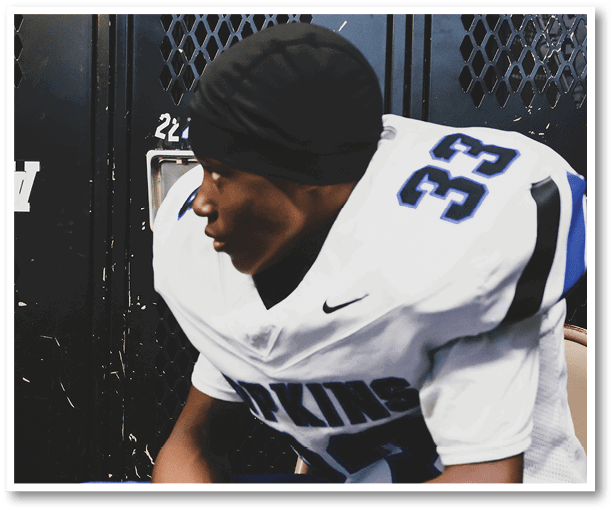 A group of football players wearing black jerseys with the number 3 on them. Description generated by AI