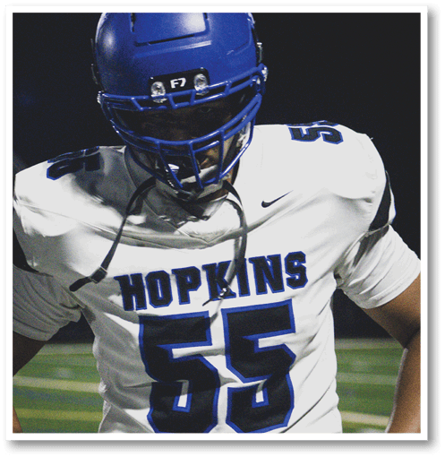 Two football players wearing black jerseys with the number 11 on them. Description generated by AI