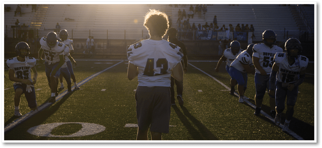A football player running on the field. Description generated by AI