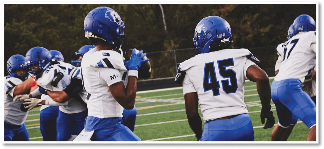 A group of football players on a field. Description generated by AI