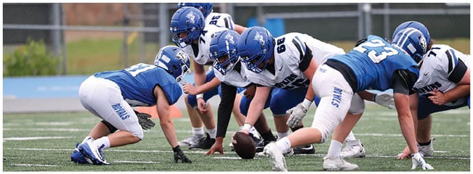 A football player is sliding on the ground. Description generated by AI
