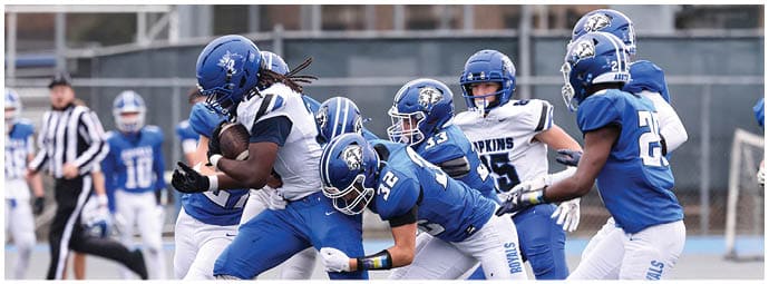 A football player is sliding on the ground. Description generated by AI