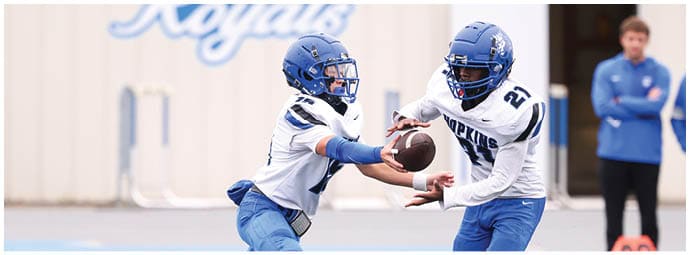 A football player is sliding on the ground. Description generated by AI