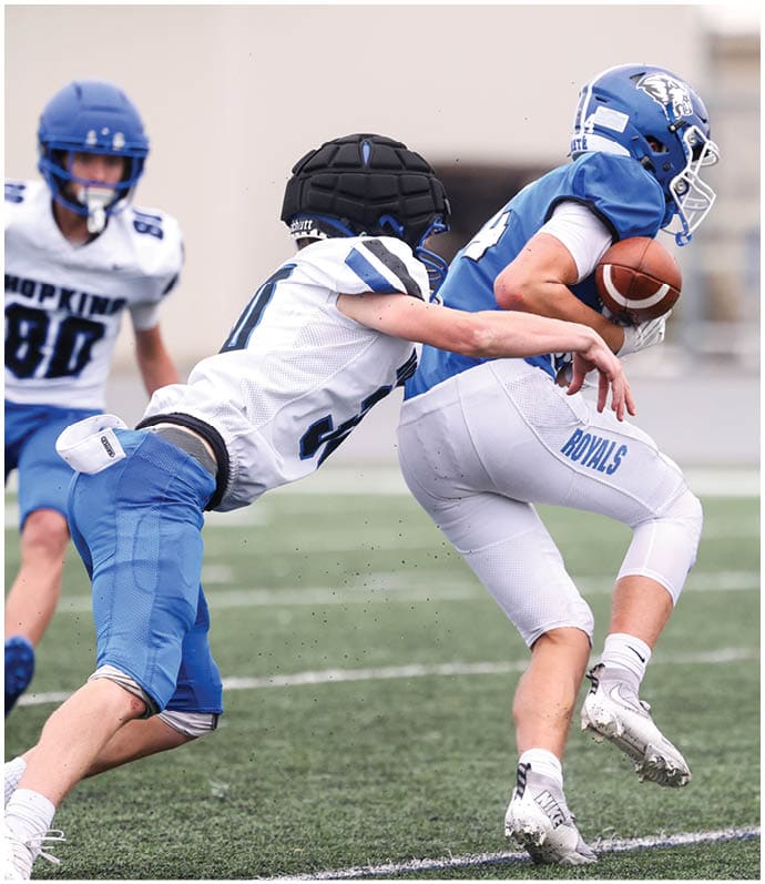 A group of football players wearing black and white uniforms. Description generated by AI