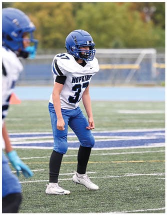 A football player running on the field. Description generated by AI