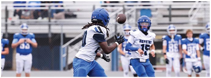 A football player is sliding on the ground. Description generated by AI