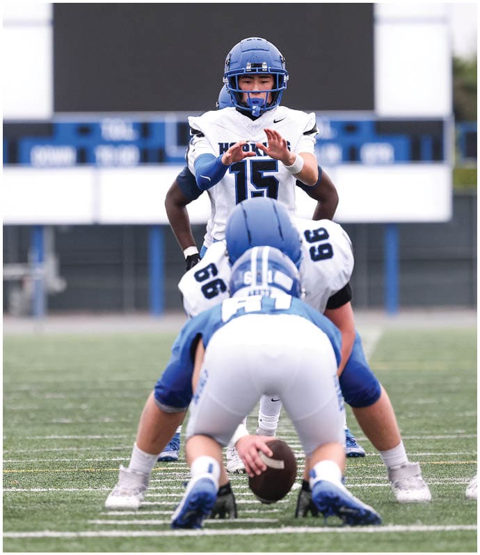 A group of football players wearing black and white uniforms. Description generated by AI