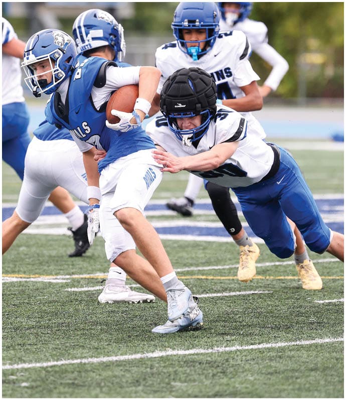 A group of football players wearing black and white uniforms. Description generated by AI