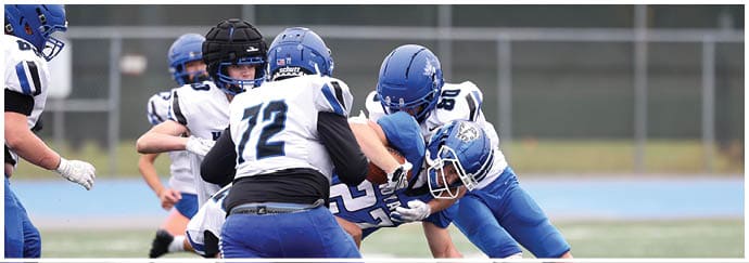 A group of football players on a field. Description generated by AI