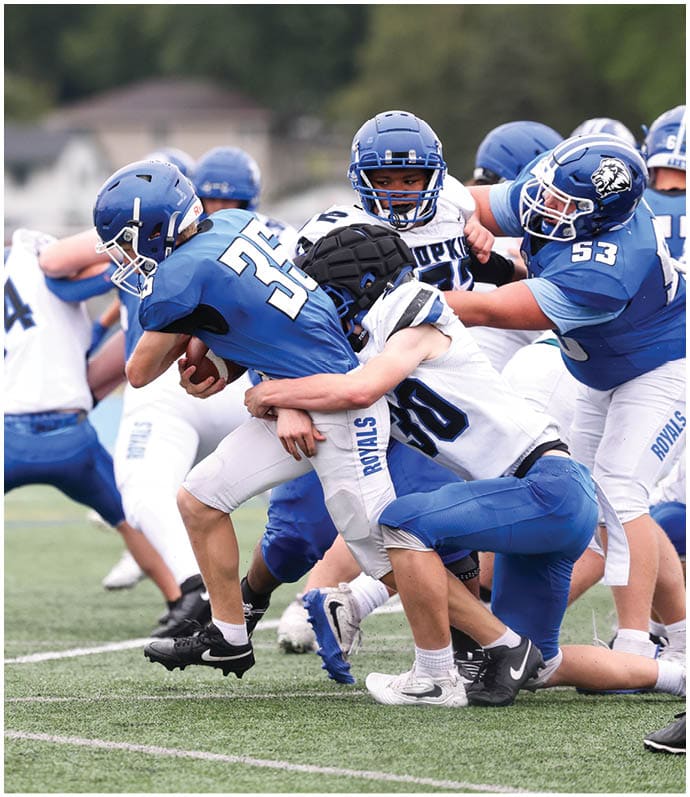A group of football players wearing black and white uniforms. Description generated by AI