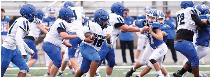A football player is sliding on the ground. Description generated by AI