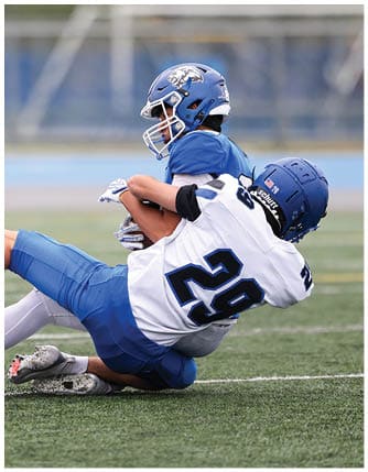 A football player running on the field. Description generated by AI
