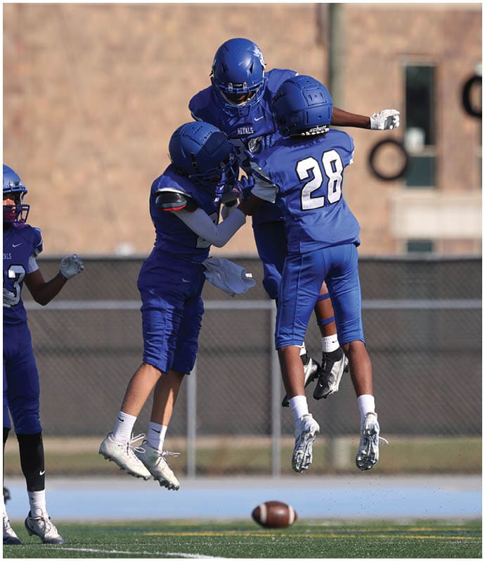 A group of football players wearing black and white uniforms. Description generated by AI