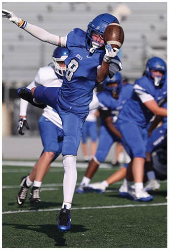 A football player running on the field. Description generated by AI