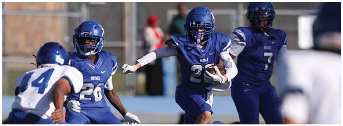 A football player is sliding on the ground. Description generated by AI