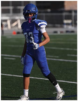 A football player running on the field. Description generated by AI