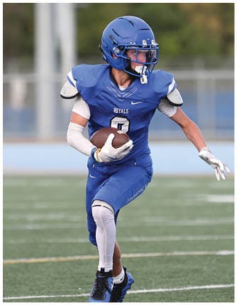 A football player running on the field. Description generated by AI