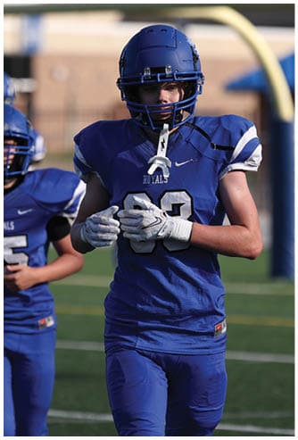 A football player running on the field. Description generated by AI